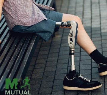 Person with a prosthetic leg sits on a bench outdoors  The logo for Mutual Orthopedics is displayed in the bottom left corner 